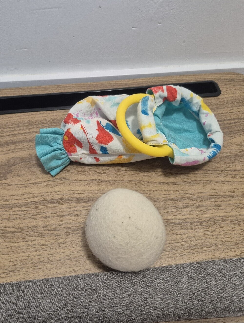 Lovevery Organic Cotton Sensory Pouch with a yellow ring And Ball